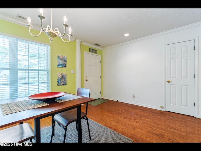 4043 Brick Path Ln SE, Southport, NC 28461 - dining room with ornamental molding, a chandelier, wood finished floors, baseboards, and recessed lighting