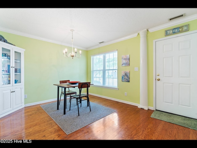 4043 Brick Path Ln SE, Southport, NC 28461 - dining area with ornamental molding, wood finished floors, baseboards, and a chandelier