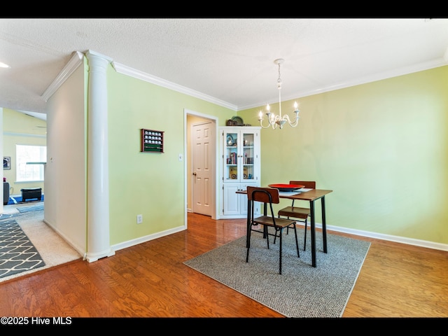 4043 Brick Path Ln SE, Southport, NC 28461 - dining area with crown molding, wood finished floors, a chandelier, and baseboards