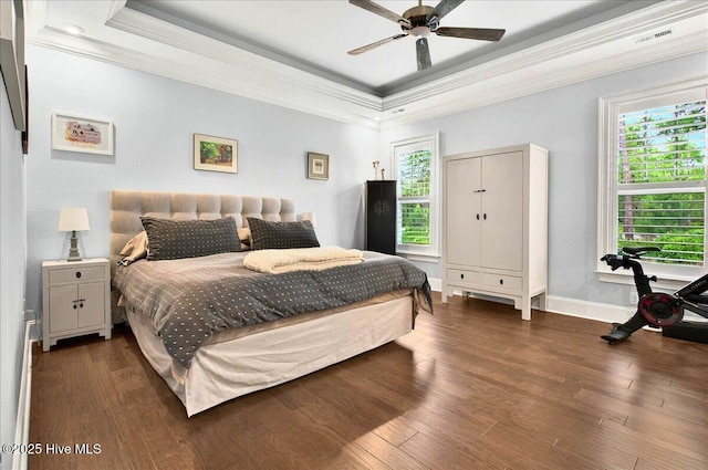 6665 Summerhill Gln SW, Ocean Isle Beach, NC 28469 - bedroom with ornamental molding, a raised ceiling, multiple windows, and wood finished floors
