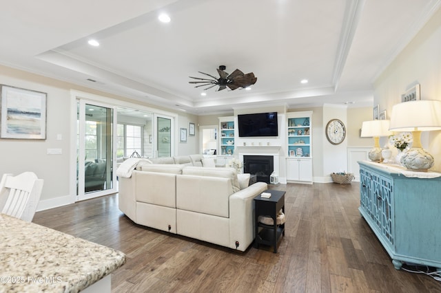 3020 Eno Ln, Leland, NC 28451 - living room featuring a raised ceiling, ornamental molding, a ceiling fan, dark wood-style floors, and recessed lighting