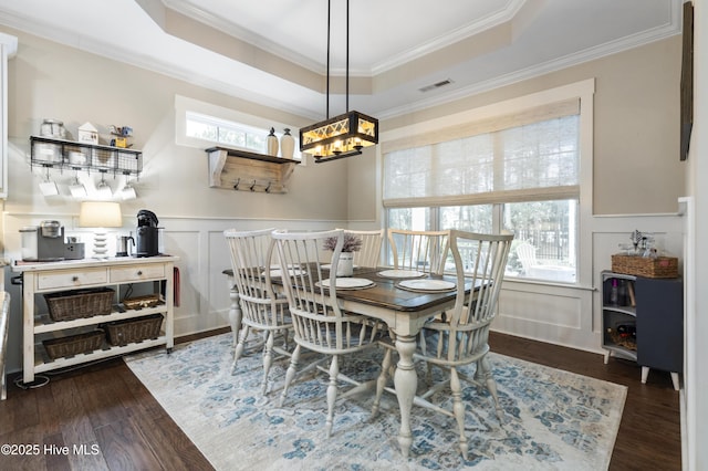 3020 Eno Ln, Leland, NC 28451 - dining area featuring a decorative wall, a chandelier, ornamental molding, wood finished floors, and a raised ceiling