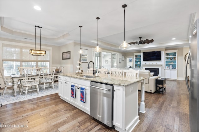 3020 Eno Ln, Leland, NC 28451 - kitchen with a tray ceiling, appliances with stainless steel finishes, crown molding, a sink, and ceiling fan