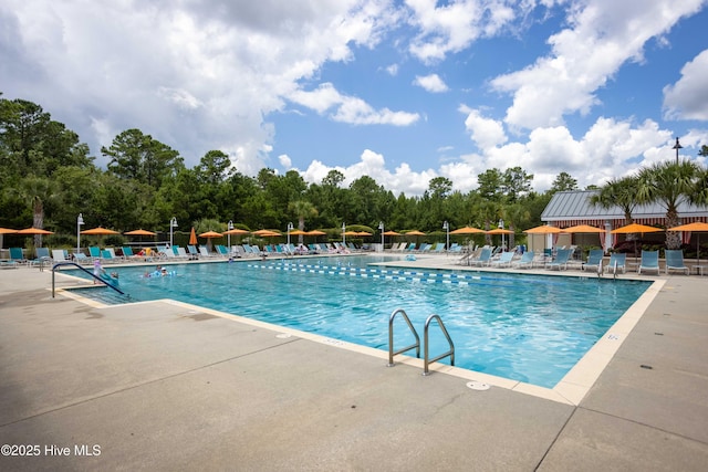 3020 Eno Ln, Leland, NC 28451 - community pool featuring a patio and view of scattered trees
