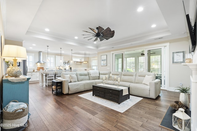 3020 Eno Ln, Leland, NC 28451 - living area featuring a raised ceiling, ceiling fan, dark wood-style flooring, crown molding, and recessed lighting