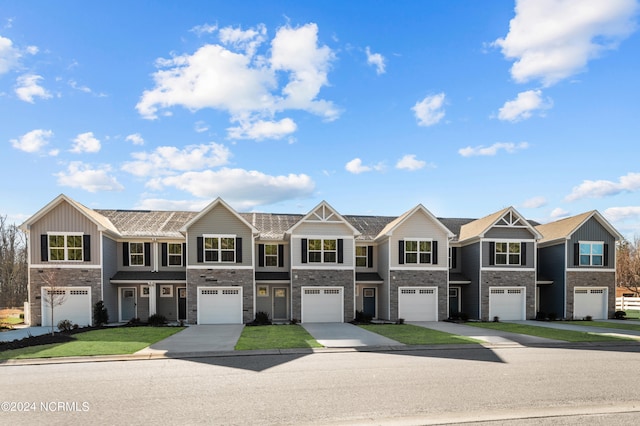 2901 Lamsberry Cir, Elizabeth City, NC 27909 - townhome / multi-family property with stone siding, an attached garage, and driveway