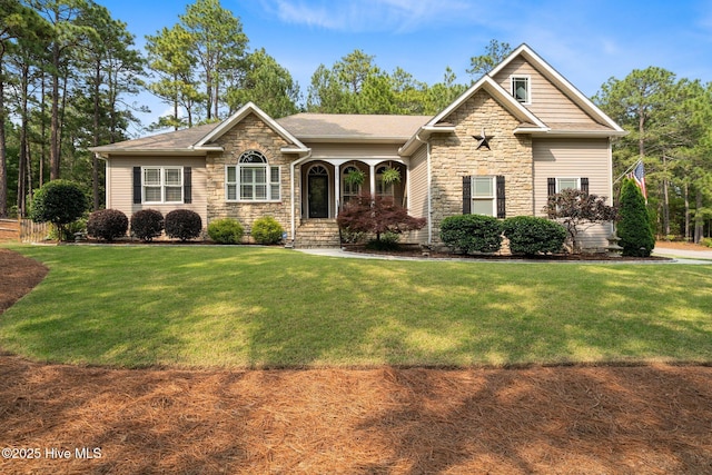195 Devonshire Ave W, Seven Lakes, NC 27376 - view of front of house featuring stone siding, a front yard, and a shingled roof