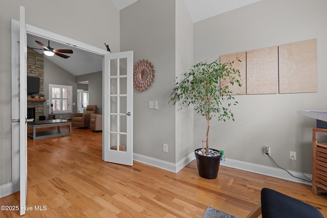 195 Devonshire Ave W, Seven Lakes, NC 27376 - sitting room with ceiling fan, wood finished floors, high vaulted ceiling, a stone fireplace, and baseboards