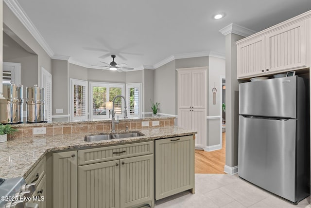 195 Devonshire Ave W, Seven Lakes, NC 27376 - kitchen featuring freestanding refrigerator, a sink, a ceiling fan, light tile patterned floors, and light stone counters