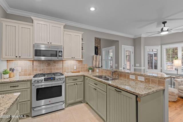 195 Devonshire Ave W, Seven Lakes, NC 27376 - kitchen featuring stainless steel appliances, a peninsula, a sink, plenty of natural light, and ornamental molding