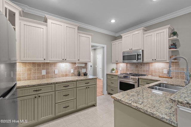 195 Devonshire Ave W, Seven Lakes, NC 27376 - kitchen with stainless steel appliances, a sink, green cabinets, open shelves, and decorative backsplash