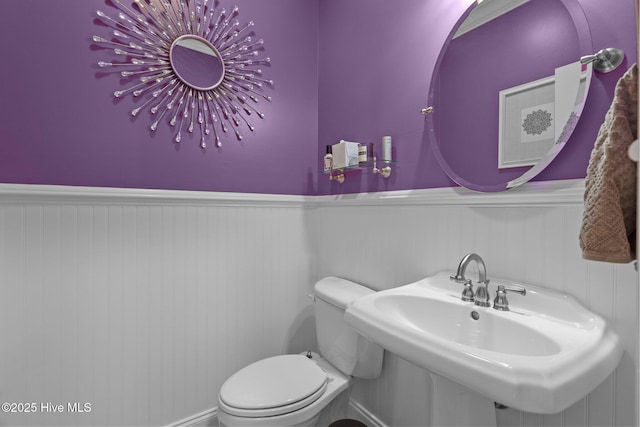195 Devonshire Ave W, Seven Lakes, NC 27376 - bathroom with toilet, a wainscoted wall, and a sink