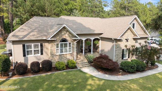 195 Devonshire Ave W, Seven Lakes, NC 27376 - view of front of home with stone siding, a front yard, and roof with shingles
