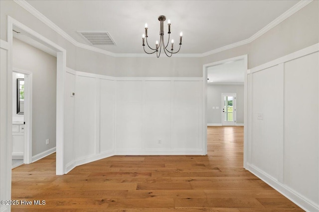 2259 Heartland Rd, Battleboro, NC 27809 - unfurnished dining area with a chandelier, light wood-type flooring, and ornamental molding