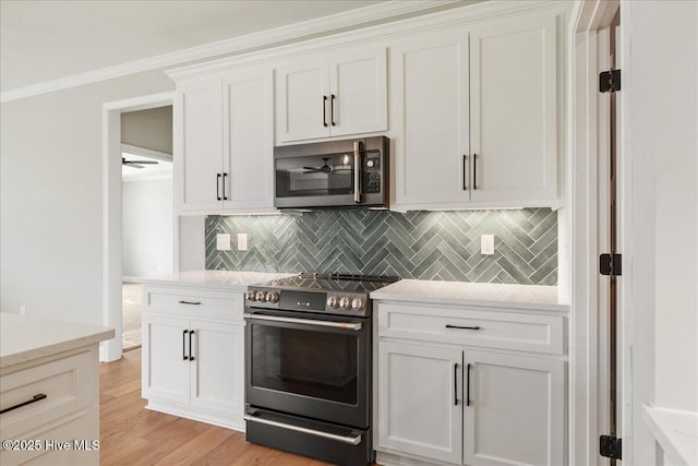 2259 Heartland Rd, Battleboro, NC 27809 - kitchen with appliances with stainless steel finishes, backsplash, white cabinets, light wood-type flooring, and light stone countertops