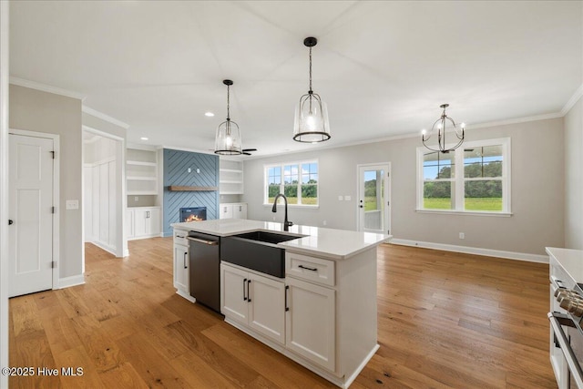 2259 Heartland Rd, Battleboro, NC 27809 - kitchen with stainless steel dishwasher, a sink, a large fireplace, ornamental molding, and light wood-style flooring