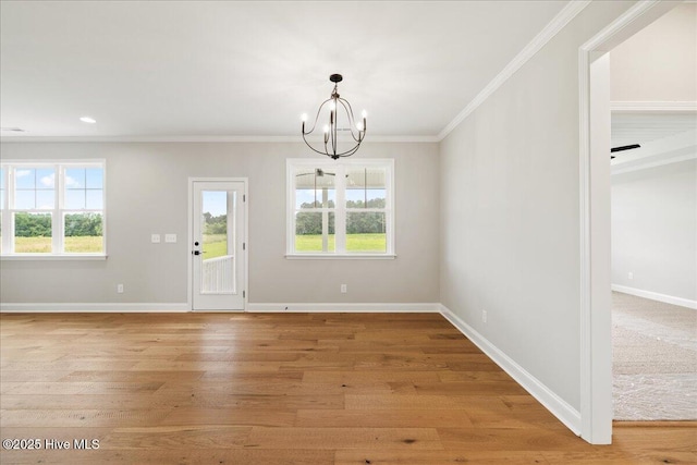 2259 Heartland Rd, Battleboro, NC 27809 - unfurnished dining area featuring a chandelier, healthy amount of natural light, crown molding, light wood finished floors, and baseboards