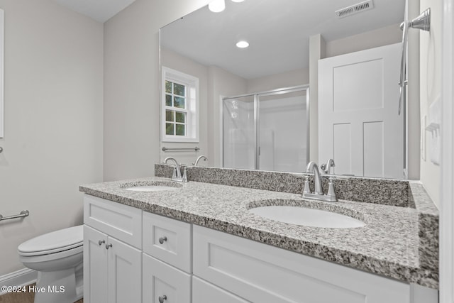 355 N Gaines St, Southern Pines, NC 28387 - bathroom with a stall shower, double vanity, and toilet