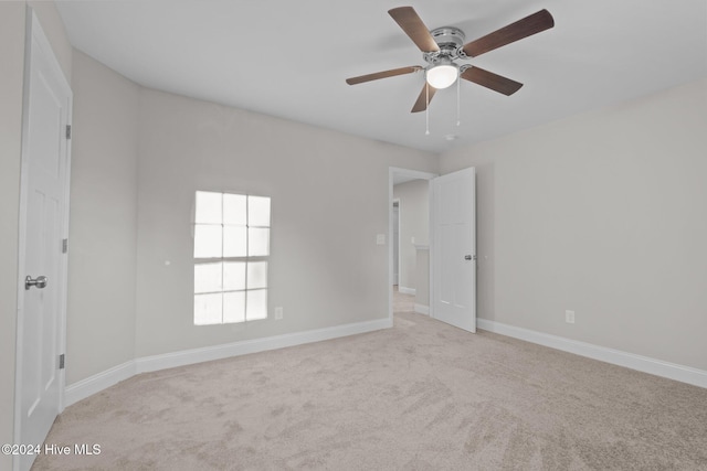 355 N Gaines St, Southern Pines, NC 28387 - unfurnished room featuring light colored carpet, a ceiling fan, and baseboards