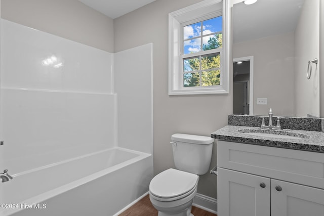 355 N Gaines St, Southern Pines, NC 28387 - full bath featuring vanity, toilet, wood finished floors, baseboards, and washtub / shower combination