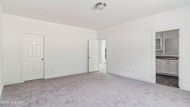 290 Boulder Dr, West End, NC 27376 - unfurnished bedroom featuring carpet floors, baseboards, ensuite bathroom, and a sink