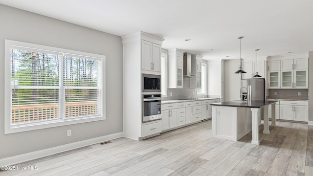 290 Boulder Dr, West End, NC 27376 - kitchen with appliances with stainless steel finishes, wall chimney exhaust hood, decorative backsplash, light wood-style flooring, and recessed lighting