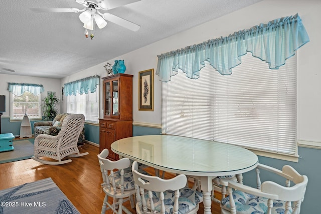 109 NE 1st St, Oak Island, NC 28465 - dining space with a textured ceiling, wood finished floors, and ceiling fan