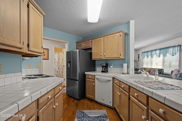 109 NE 1st St, Oak Island, NC 28465 - kitchen featuring white dishwasher, stainless steel refrigerator with ice dispenser, dark wood finished floors, a sink, and tile counters