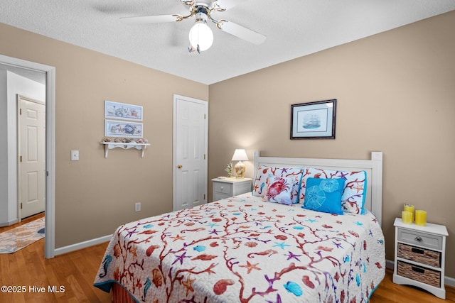 109 NE 1st St, Oak Island, NC 28465 - bedroom with wood finished floors, baseboards, and a ceiling fan