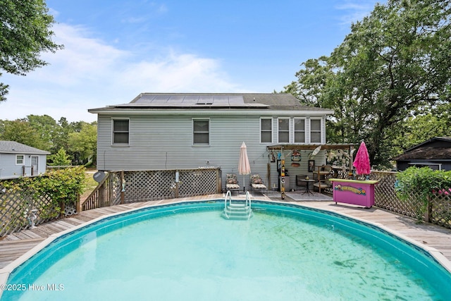 109 NE 1st St, Oak Island, NC 28465 - swimming pool featuring a wooden deck