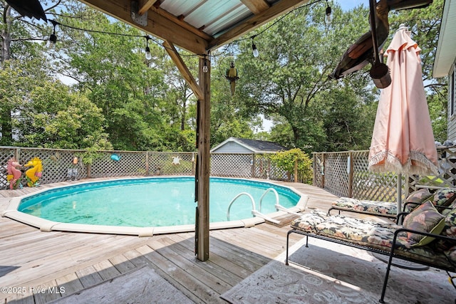 109 NE 1st St, Oak Island, NC 28465 - view of pool with a deck and view of wooded area