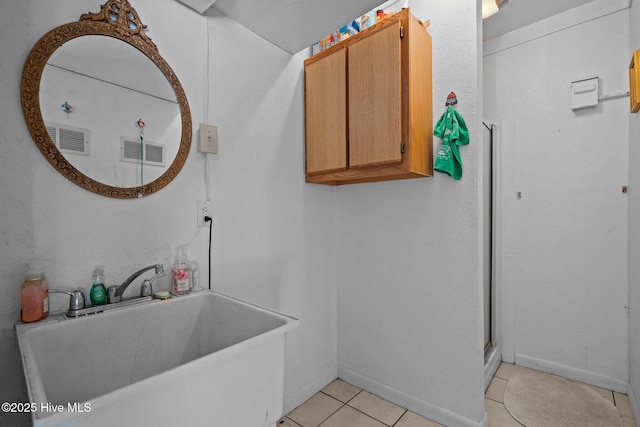 109 NE 1st St, Oak Island, NC 28465 - full bath with a sink, tile patterned flooring, baseboards, and an enclosed shower