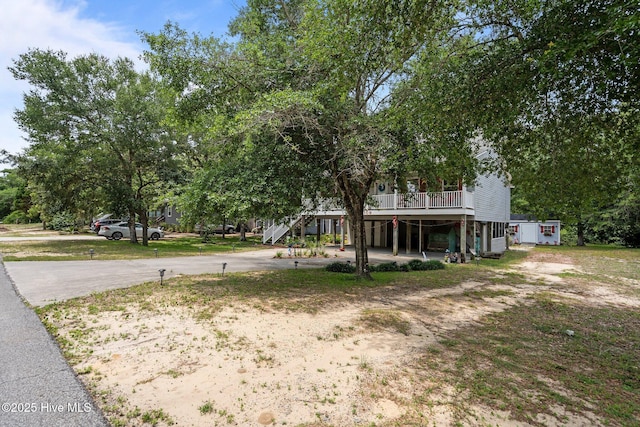 109 NE 1st St, Oak Island, NC 28465 - view of yard featuring driveway and stairs