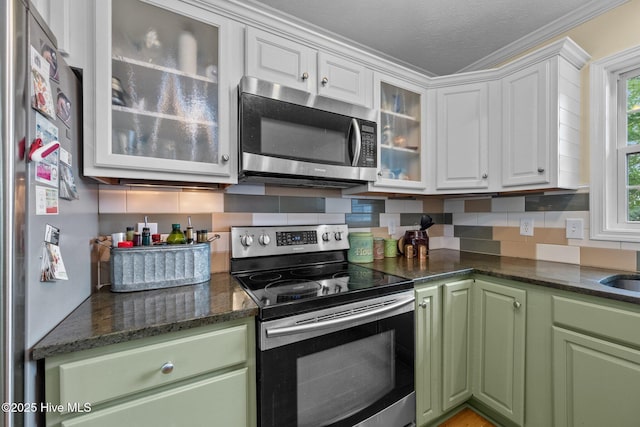 206 Lansing Ct, Jacksonville, NC 28540 - kitchen with stainless steel appliances, white cabinets, green cabinets, backsplash, and crown molding