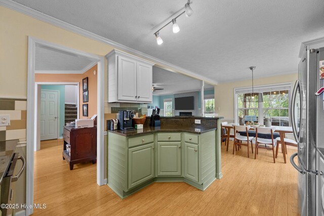 206 Lansing Ct, Jacksonville, NC 28540 - kitchen featuring green cabinets, freestanding refrigerator, light wood-type flooring, dark countertops, and white cabinetry