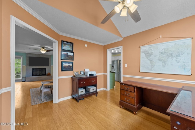 206 Lansing Ct, Jacksonville, NC 28540 - office featuring ceiling fan, light wood-type flooring, a brick fireplace, lofted ceiling, and crown molding