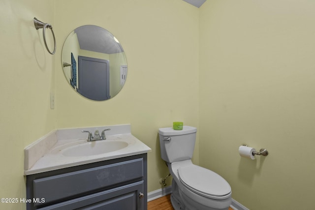 206 Lansing Ct, Jacksonville, NC 28540 - half bathroom featuring vanity, toilet, baseboards, and wood finished floors