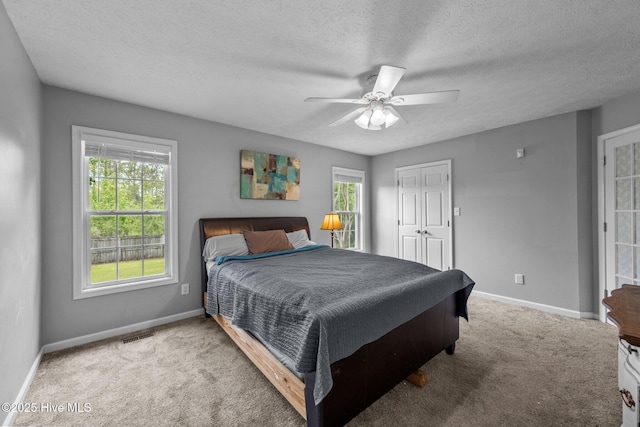 206 Lansing Ct, Jacksonville, NC 28540 - carpeted bedroom with baseboards, ceiling fan, and a textured ceiling