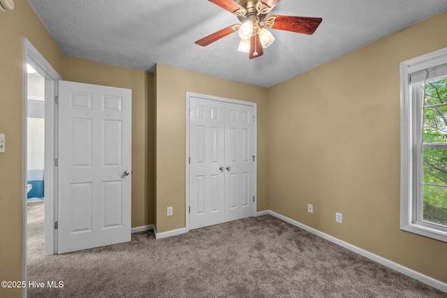 206 Lansing Ct, Jacksonville, NC 28540 - unfurnished bedroom with carpet floors, a closet, baseboards, ceiling fan, and a textured ceiling