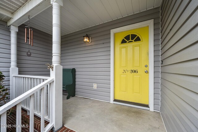 206 Lansing Ct, Jacksonville, NC 28540 - view of exterior entry featuring a porch