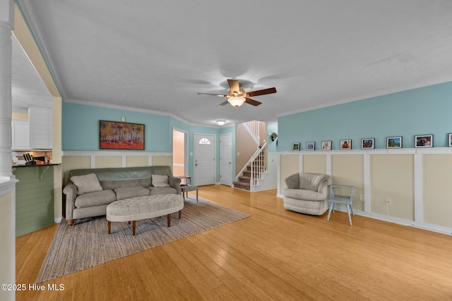 206 Lansing Ct, Jacksonville, NC 28540 - living area with a ceiling fan, stairs, wood finished floors, and crown molding