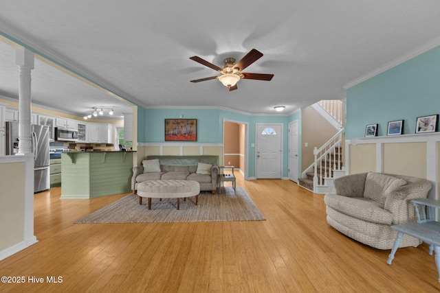 206 Lansing Ct, Jacksonville, NC 28540 - living area with ceiling fan, light wood-type flooring, ornamental molding, and stairs