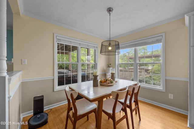 206 Lansing Ct, Jacksonville, NC 28540 - dining area with light wood-style flooring, baseboards, ornamental molding, and a textured ceiling