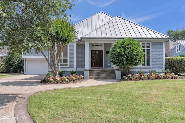 2021 Seawind Ln, Wilmington, NC 28405 - view of front facade featuring a front lawn, driveway, metal roof, and a garage