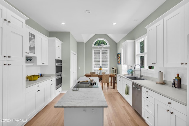 2021 Seawind Ln, Wilmington, NC 28405 - kitchen featuring a sink, appliances with stainless steel finishes, a kitchen island, light countertops, and lofted ceiling