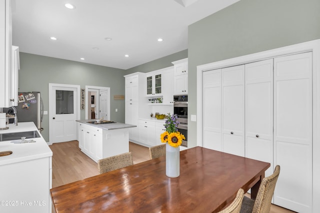 2021 Seawind Ln, Wilmington, NC 28405 - kitchen with stainless steel appliances, a center island, white cabinetry, light wood finished floors, and recessed lighting