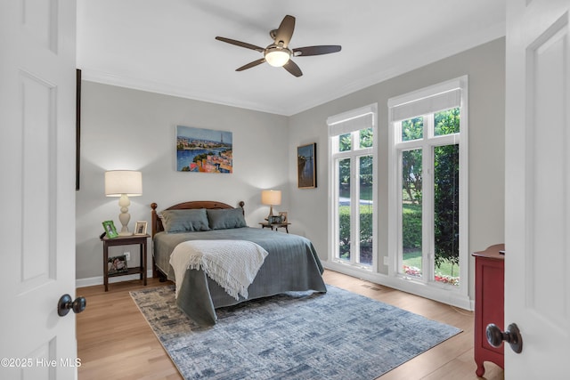 2021 Seawind Ln, Wilmington, NC 28405 - bedroom featuring light wood-style flooring, ornamental molding, ceiling fan, and baseboards