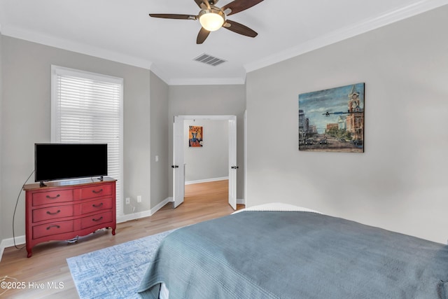 2021 Seawind Ln, Wilmington, NC 28405 - bedroom with ornamental molding, wood finished floors, baseboards, and a ceiling fan