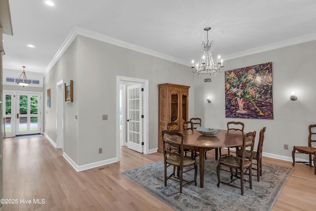 2021 Seawind Ln, Wilmington, NC 28405 - dining room with light wood finished floors, a chandelier, ornamental molding, baseboards, and recessed lighting