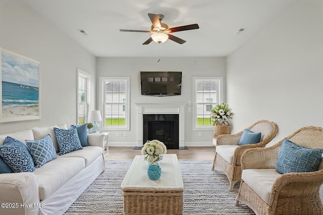 33 Chippewa Ln, Rocky Point, NC 28457 - living area featuring ceiling fan, light wood-type flooring, baseboards, and a fireplace